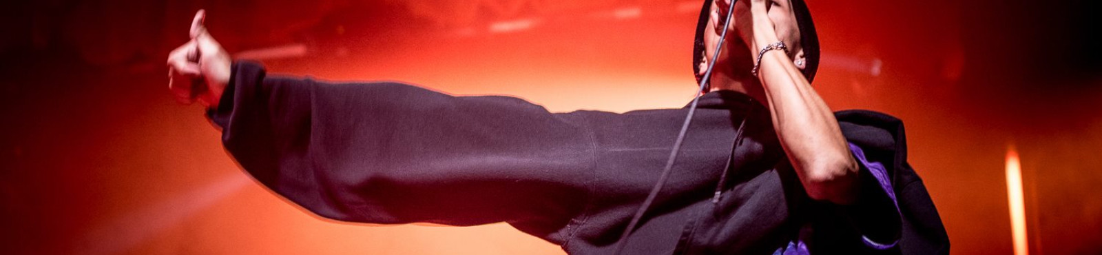 a rapper mid-performance not making a rude gesture