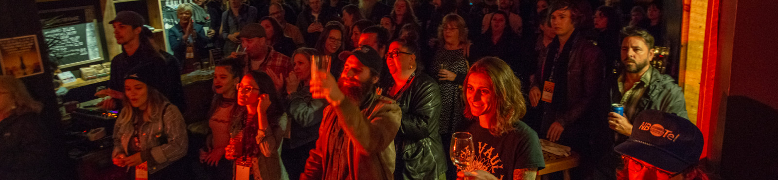 crowd of people enjoying the music except that one guy at the back