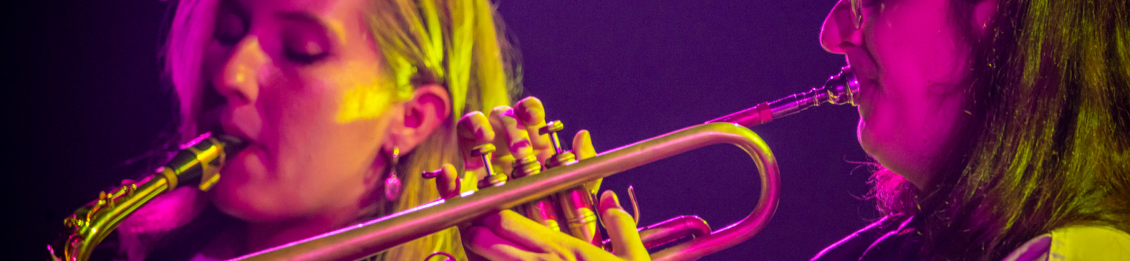 Musicians playing saxophone and trumpet. Photo by LP Chiasson